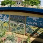 Tryptic mosaic murals representing three plant communities in Calif: desert with spring bloom, mountain grassland, and oakwoodland. Drawings by Alrie Middlebrook. Mosaic by Christina Yaconelli.