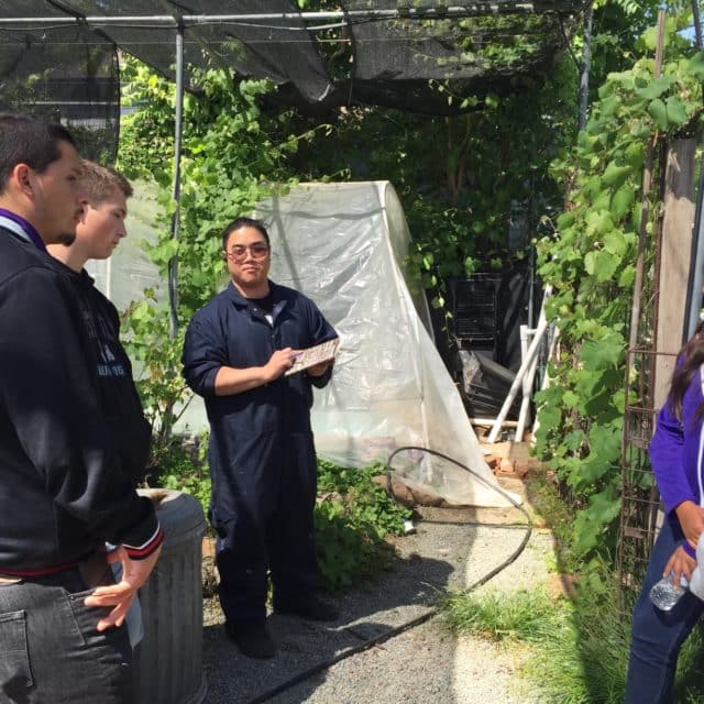 Aquaponics farmer and mentor volunteering to teach high school students at CNGF aquaponics lab